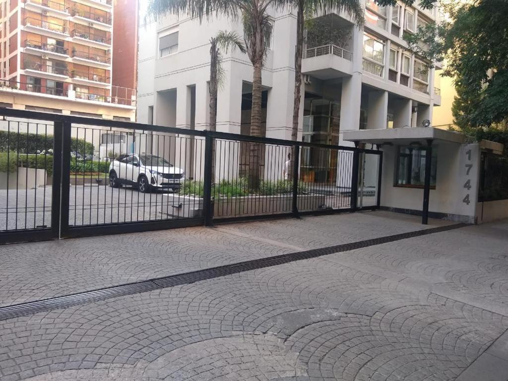a black fence with a car parked in front of a building at Torre Hernandez in Buenos Aires