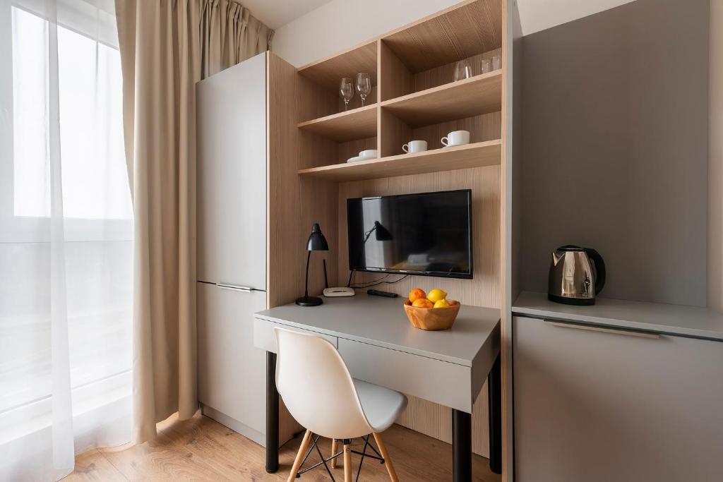 Televízia a/alebo spoločenská miestnosť v ubytovaní Aparthotel City Break Wolska