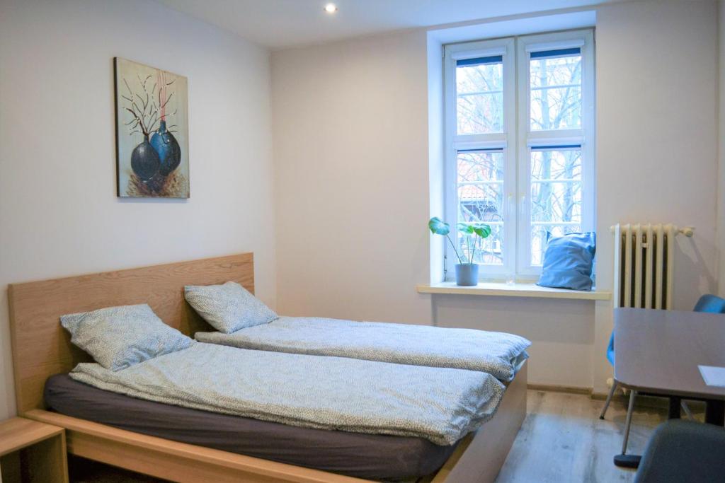 a bed in a room with a window at One-room apartment on Ogarna St in the Old Town in Gdańsk