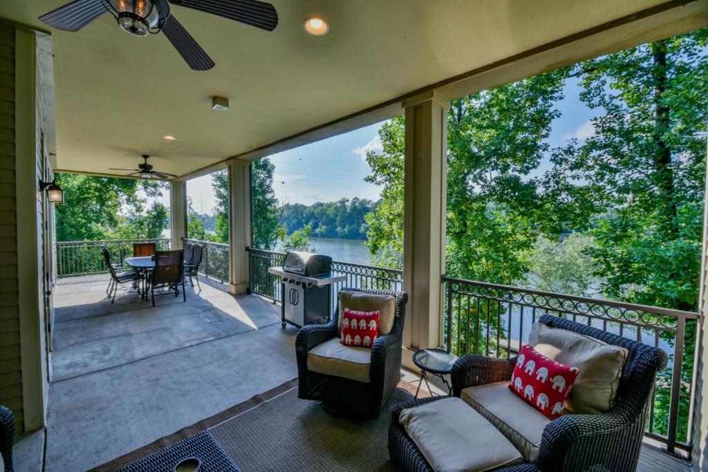 a screened in porch with a view of the water at Land of Oz in Tuscaloosa