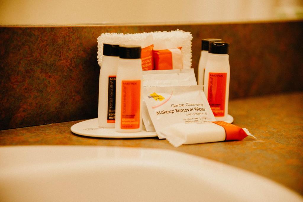 two bottles of cleaning products sitting on a bathroom counter at Super 8 by Wyndham Revelstoke BC in Revelstoke