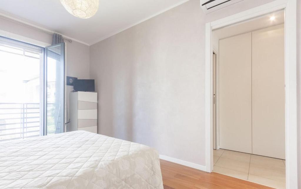 Łóżko lub łóżka w pokoju w obiekcie CaseOspitali - Casa La Vela, raffinato bilocale con balcone