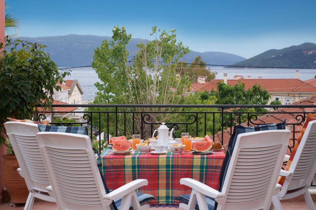 a table with a tea set on a balcony at Stella's Place in Karavomylos