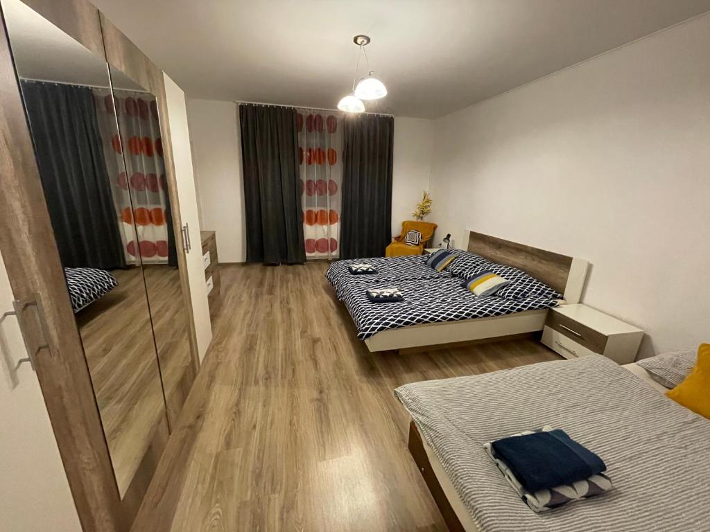 a bedroom with two beds and a mirror at Rozľahlý apartmán v centre Martina in Martin