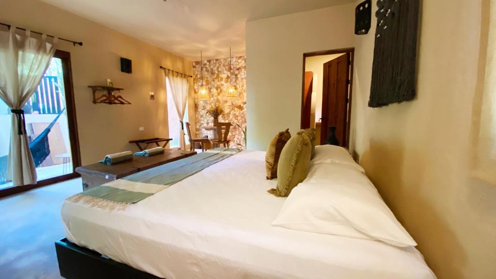 a large white bed in a room with a window at Hotel Boutique Refugio 41 in Valladolid