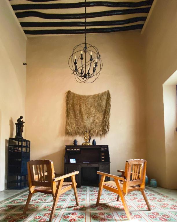 a living room with two chairs and a piano at Hotel Boutique Refugio 41 in Valladolid