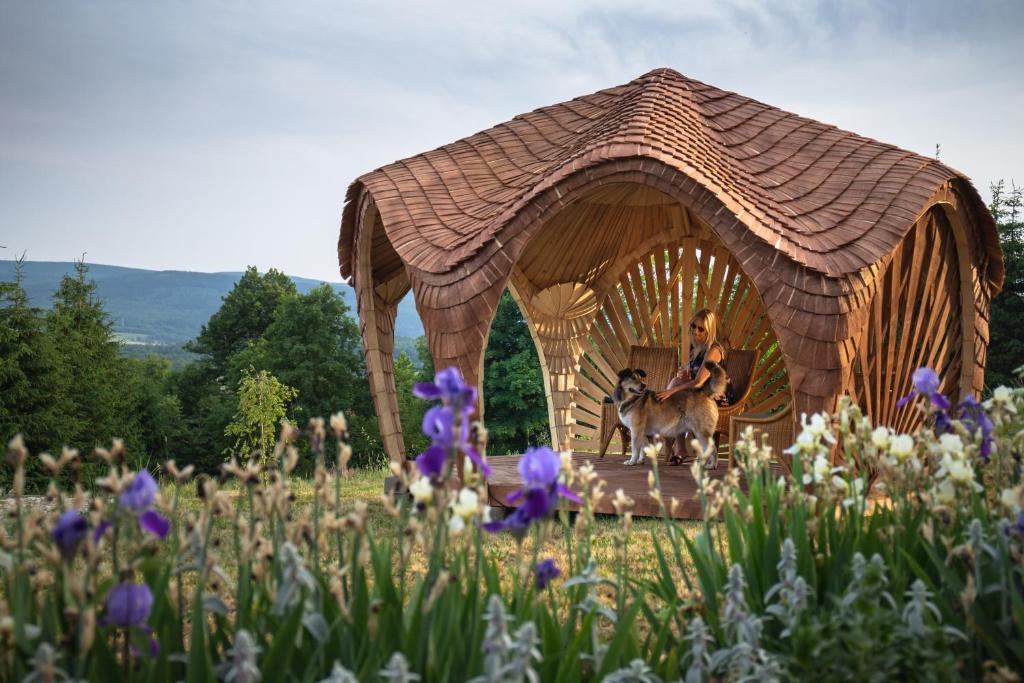 a woman sitting on a horse in a gazebo at Bonaluti in Mirsk