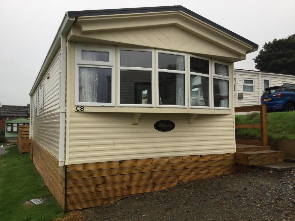 a tiny house with a large window on it at C8 in Aberystwyth
