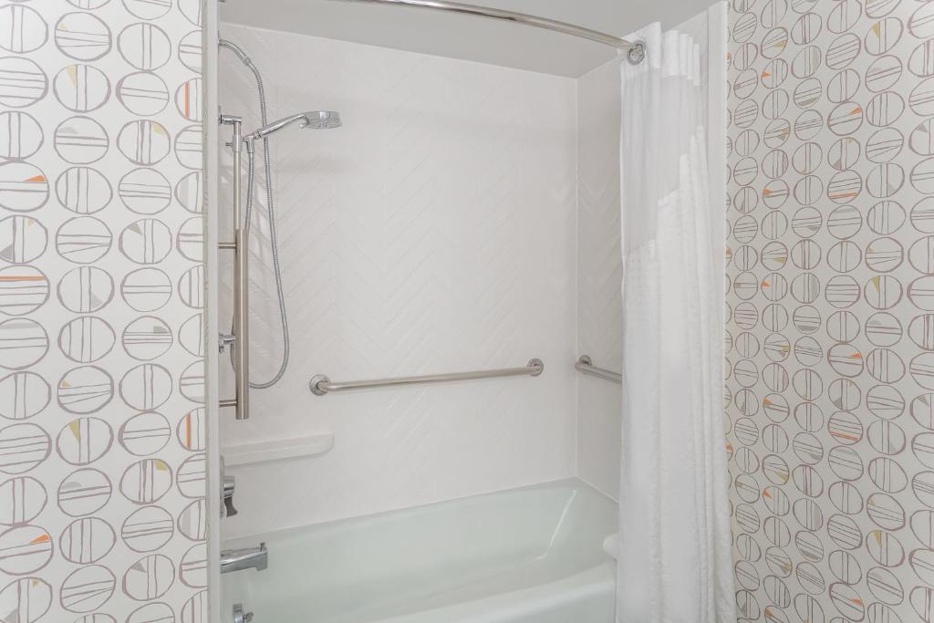 a bathroom with a shower with a shower curtain at Holiday Inn Rockford, an IHG Hotel in Rockford