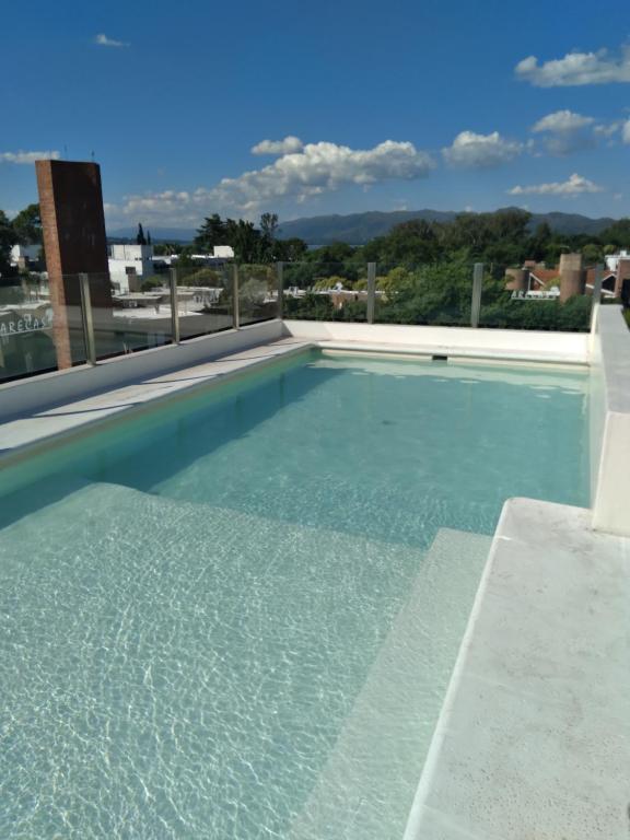 a swimming pool with a clear blue water at Arecas in Villa Carlos Paz