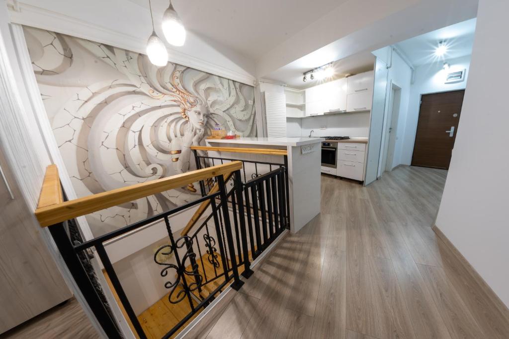 a hallway with a staircase with a wall mural at Parliament 200sqm Loft Style 1BR AP w private garden in Bucharest