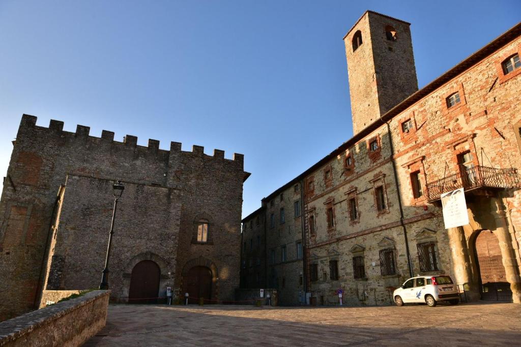 a white car parked in front of a castle at CASA DI NONNA RINDA-Via del Castello n6 in Monte Santa Maria Tiberina