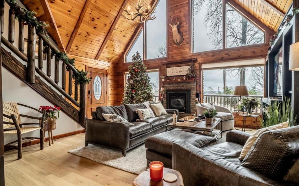 a living room with couches and a fireplace at Minnies Mountain Lake House in La Follette