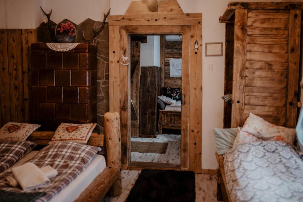a bedroom with two beds and a mirror at Chatka Zapiecek in Krościenko