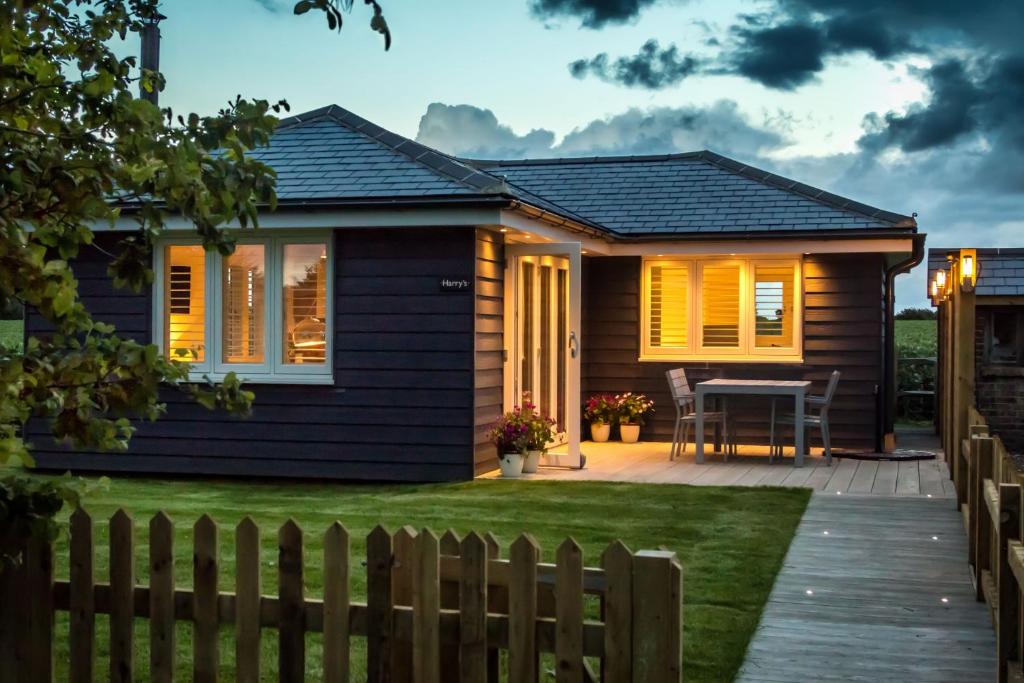 a house with a fence in front of it at Harry's at Spire Cottage Dog friendly cottage in Chichester