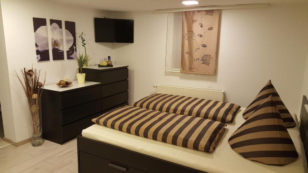 a living room with two cushions on a bed at Ferienwohnung Nicole in Schneeberg