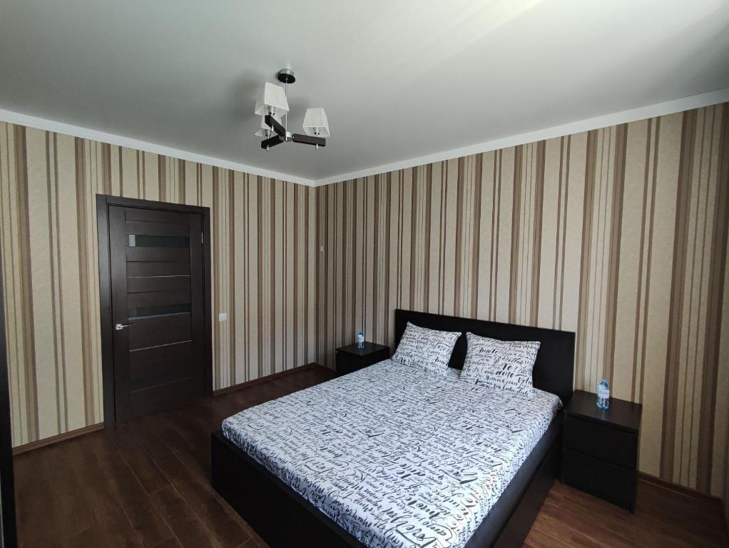 a bedroom with a bed and a brown door at Designer apartment in THE CENTER in Pyatigorsk