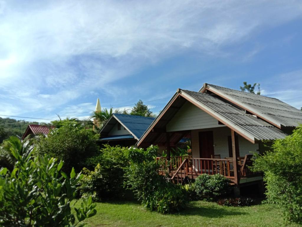 a house with a porch and a roof at Cha Bungalow in Ko Yao Noi