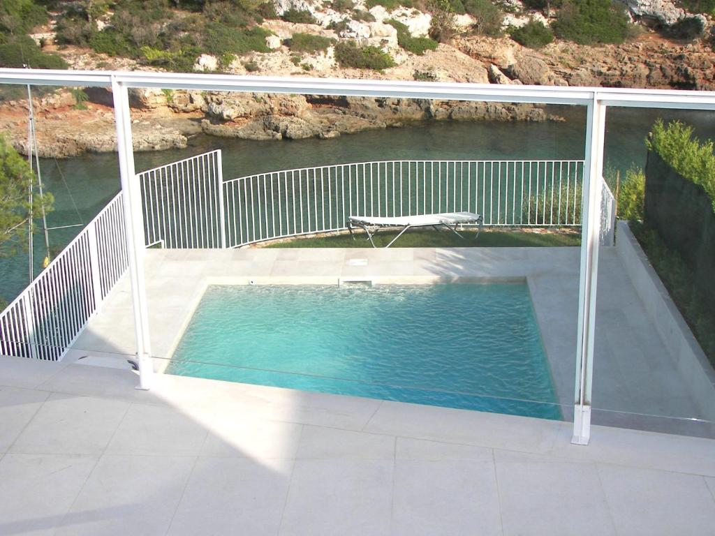 a swimming pool on the deck of a house at Villa Terra in Cala en Blanes