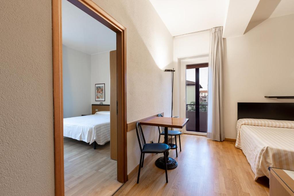 Postel nebo postele na pokoji v ubytování Hotel Nuova Grosseto