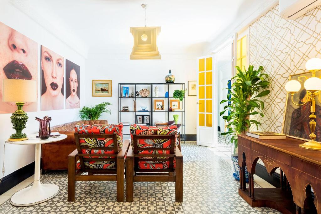 a living room with a couch and a table at Genteel Home Romanilla in Granada