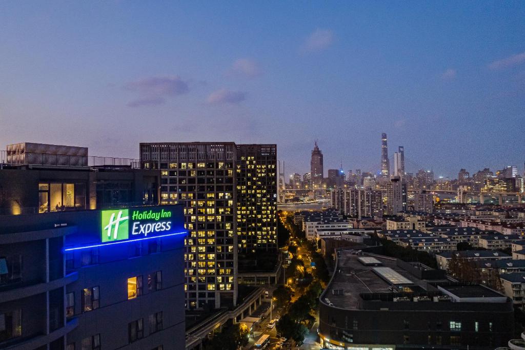 a view of a city skyline at night at Holiday Inn Express Shanghai Expo Centre, an IHG Hotel in Shanghai