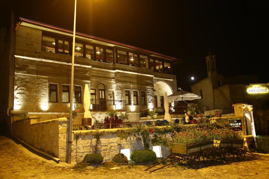 a building with flowers in front of it at night at NOSTALJİ CAVE SUİT HOTEL in Nevşehir