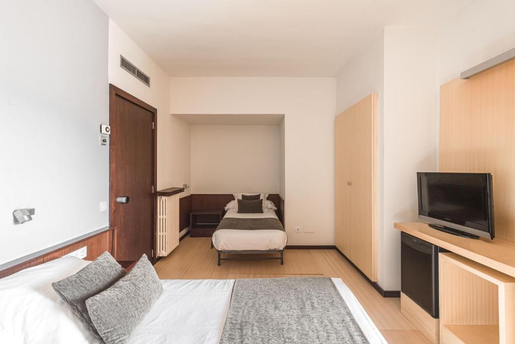 Posteľ alebo postele v izbe v ubytovaní Hotel Emporda