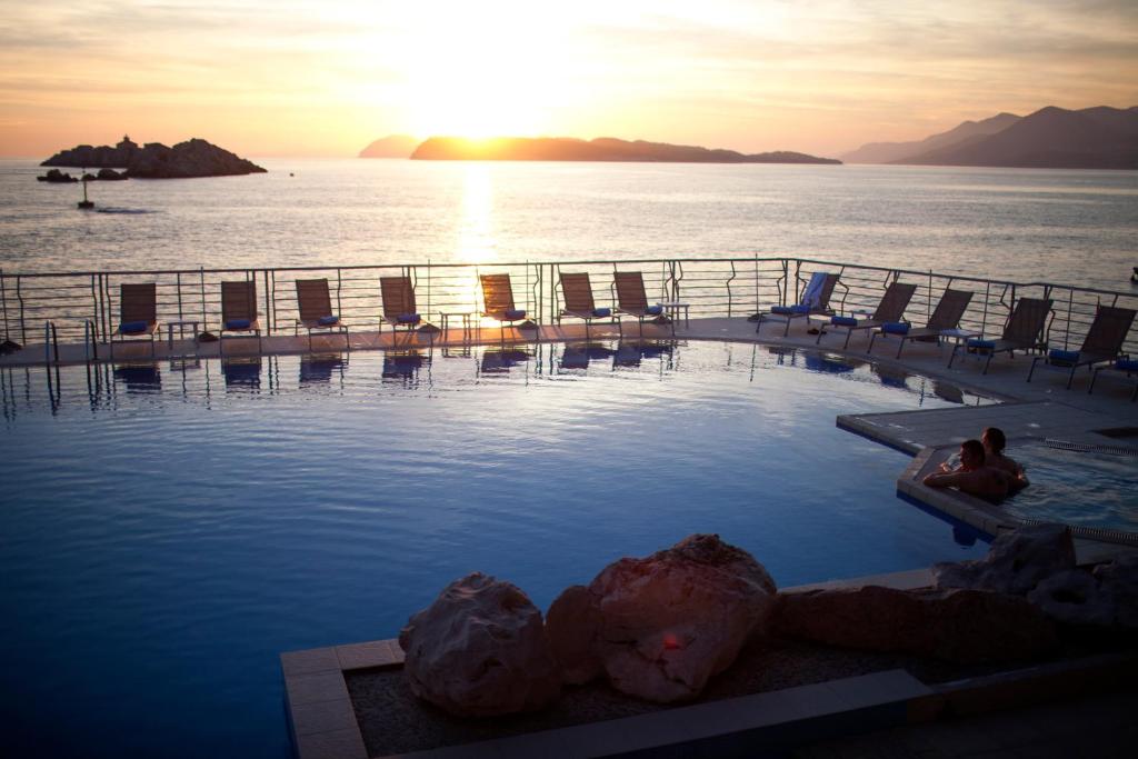 a person sitting in a swimming pool on a cruise ship at Hotel Dubrovnik Palace in Dubrovnik
