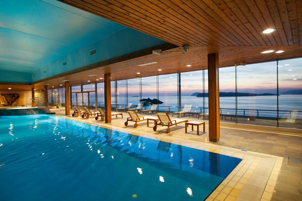 a swimming pool with a view of the ocean at Hotel Dubrovnik Palace in Dubrovnik