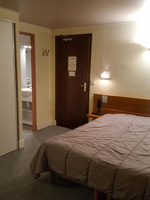 Postel nebo postele na pokoji v ubytování Hôtel Restaurant Glaizette