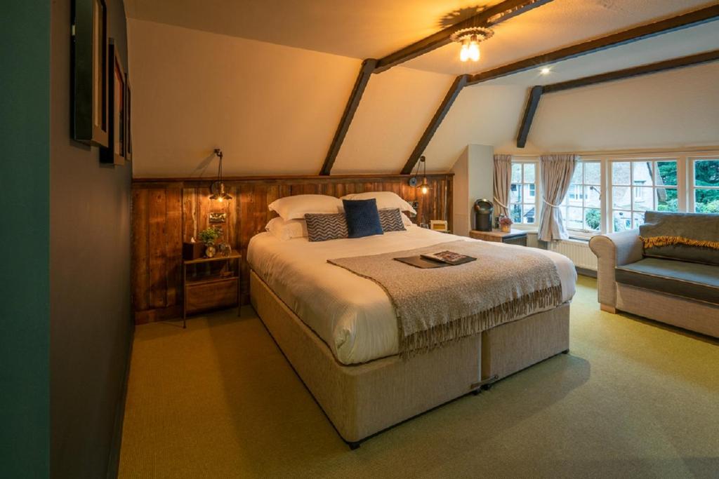 a bedroom with a large bed and a couch at Castle Inn in West Lulworth
