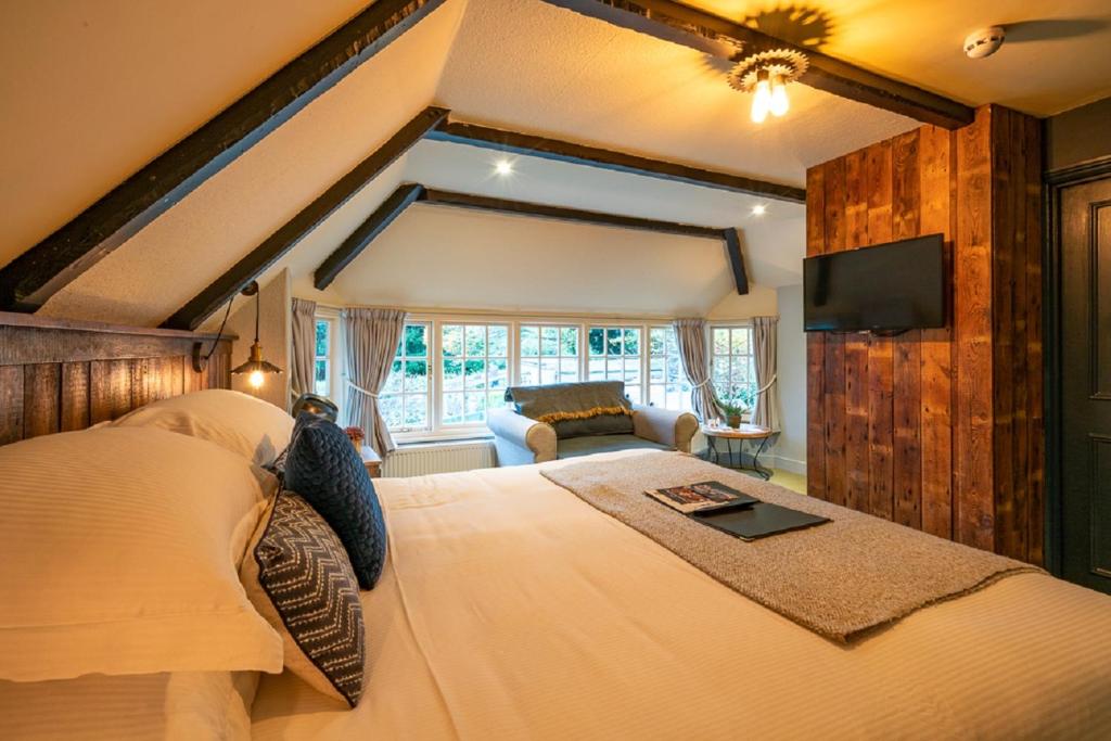 a bedroom with a large bed and a couch at Castle Inn in West Lulworth
