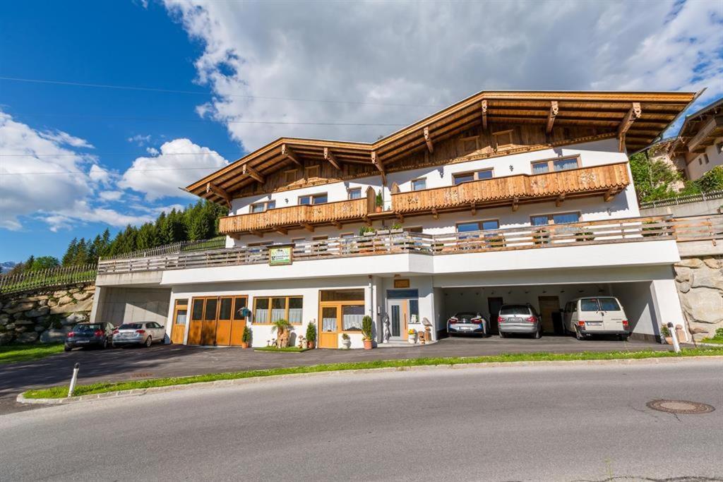 ein großes Gebäude mit Autos auf einem Parkplatz in der Unterkunft Ferienwohnung Natural B in Gerlosberg
