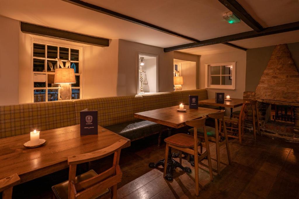 a restaurant with two tables and a couch in a room at Castle Inn in West Lulworth