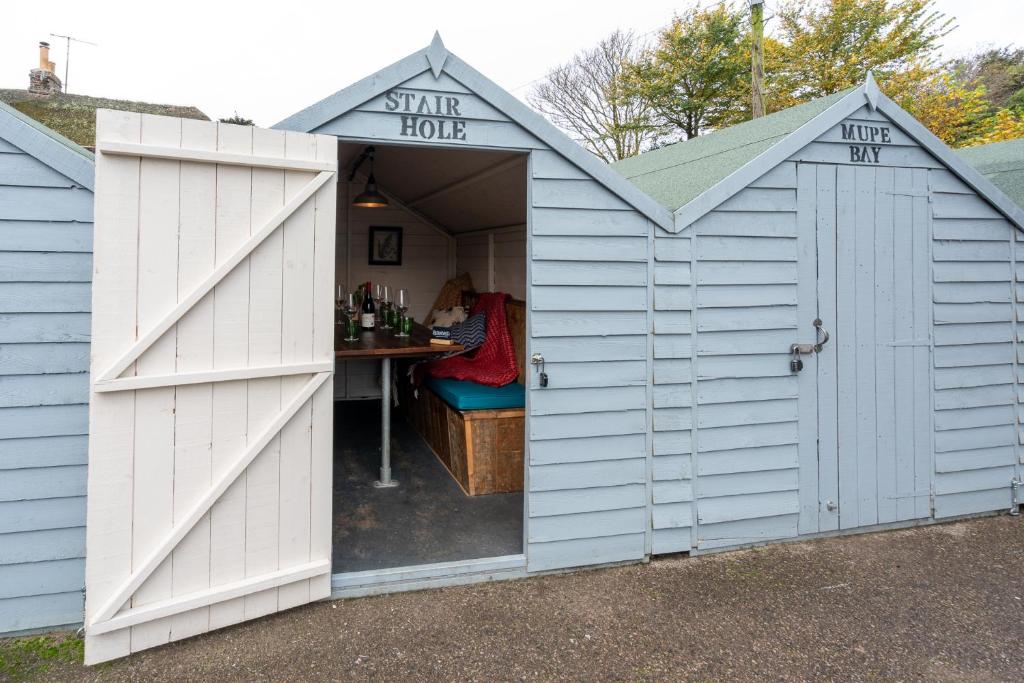 a white shed with a table in it at Castle Inn in West Lulworth