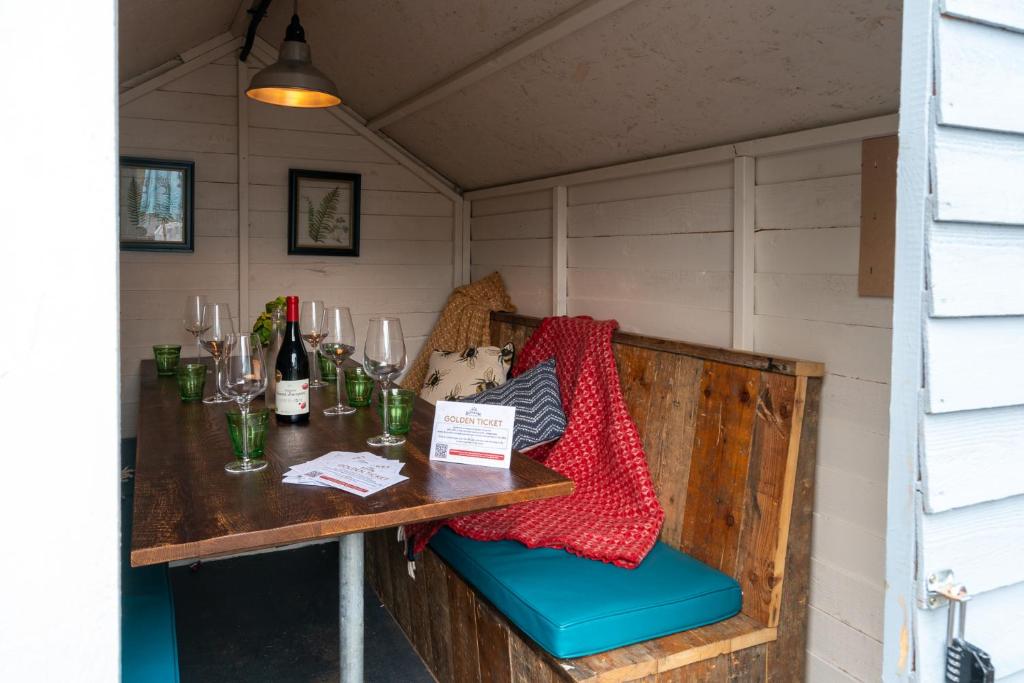 a table in a small room with a table and wine glasses at Castle Inn in West Lulworth
