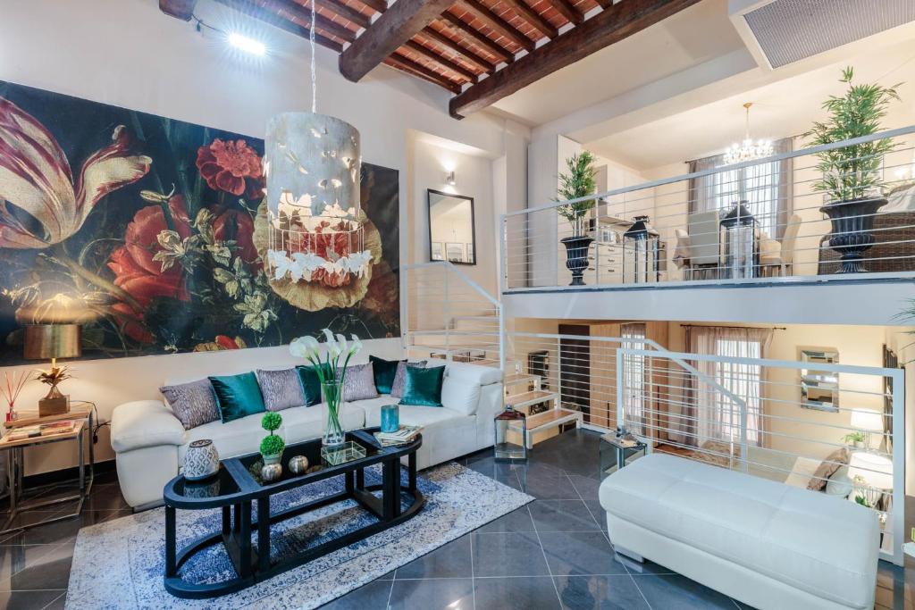 a living room with a couch and a table at CASA EDA, Modern Contemporary Central Apartment inside the Walls of Lucca in Lucca