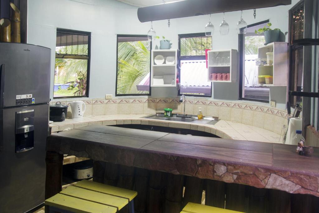 a kitchen with a large island in the middle at Cacao Lodge and Tours in Fortuna