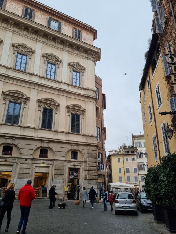 a group of people walking in front of a building at Paradise Penthouse Suite Amazing View in Rome