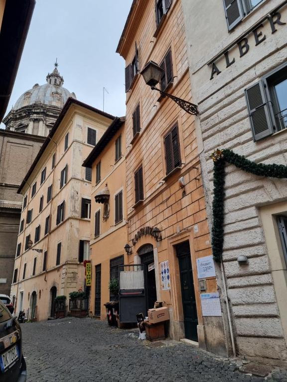 a group of buildings on a street with a dome at Paradise Penthouse Suite Amazing View in Rome