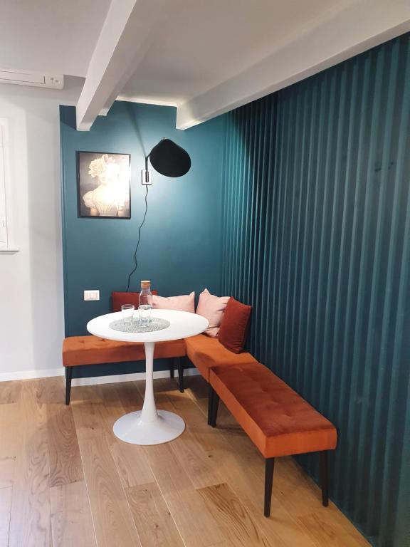 a dining room with a white table and two benches at Paradise Penthouse Suite Amazing View in Rome