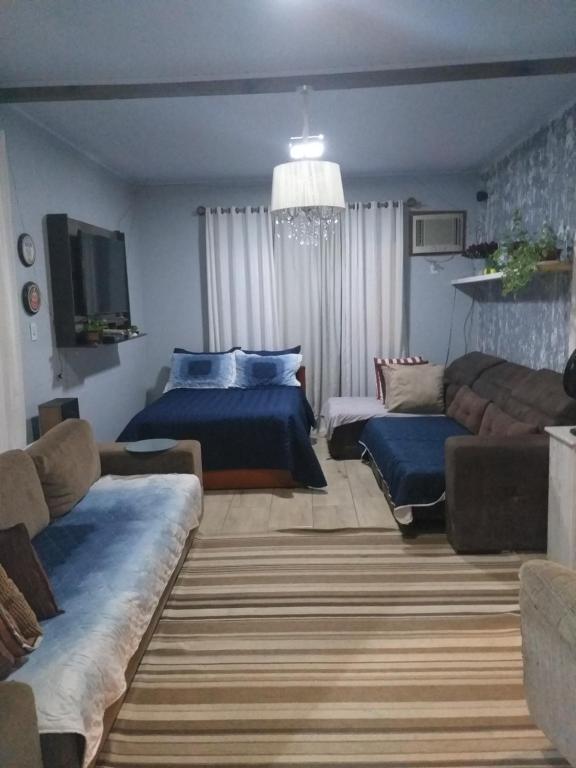 sala de estar con 2 camas y sofá en Casa na praia do Campeche, en Florianópolis