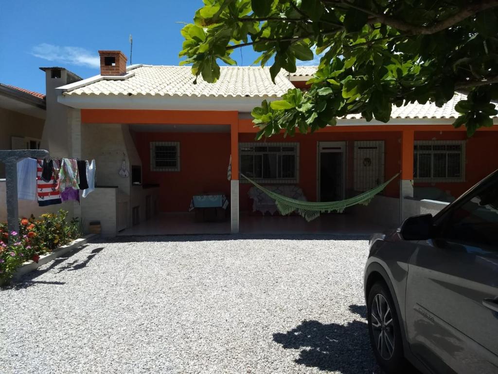 a house with a car parked in front of it at Casa de Praia in Governador Celso Ramos