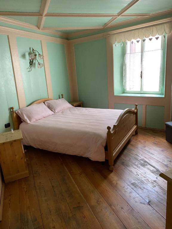 Postel nebo postele na pokoji v ubytování Casa Mia Fiemme