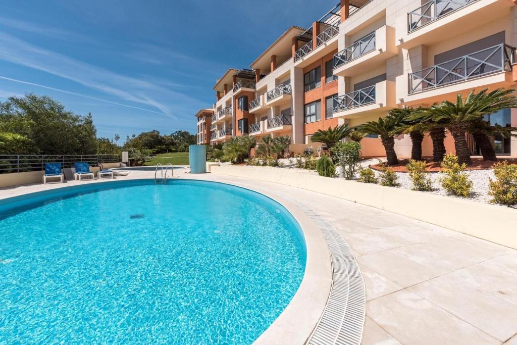 a swimming pool in front of a apartment building at 2 Terrace Town House in Albufeira