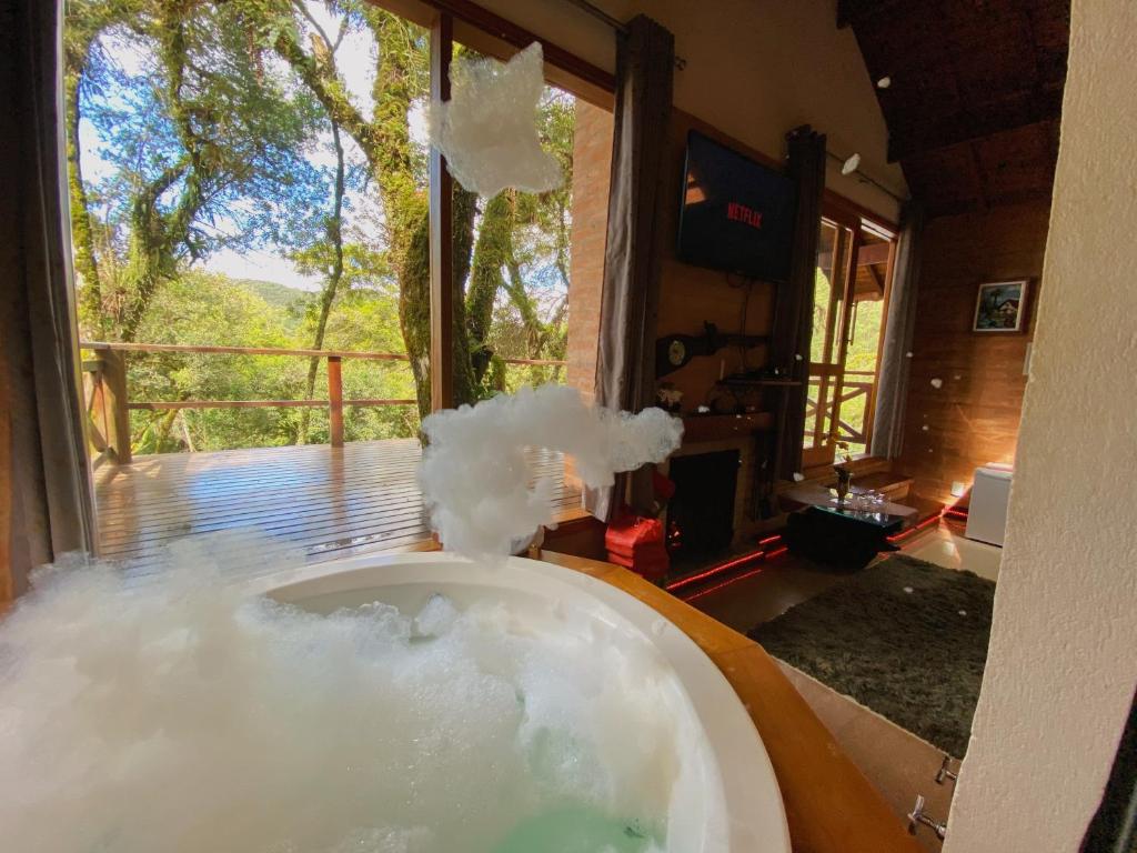 a bath tub filled with lots of smoke in a room at Vivie Pousada in Monte Verde