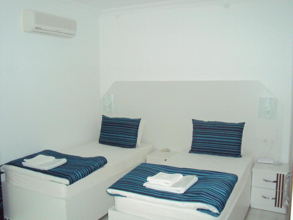 Postel nebo postele na pokoji v ubytování Teos Hotel