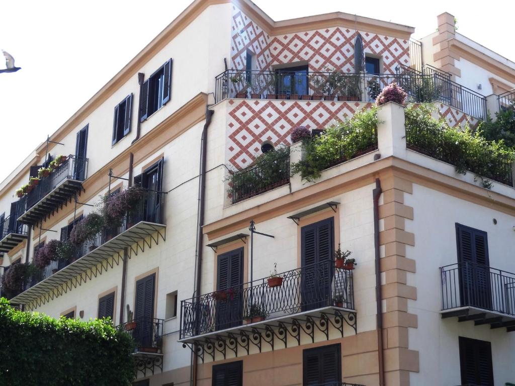 a building with balconies and plants on it at Casa Giuditta Palermo Central in Palermo