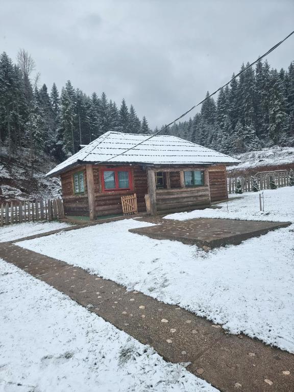 a log cabin with snow in front of it at Mala koliba Dolina mira in Pale